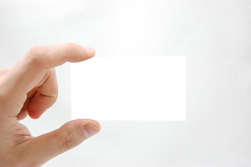 Hand holding blank white business card mockup