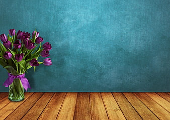 Purple Tulips in Glass Vase on Wooden Table with Blue Wall