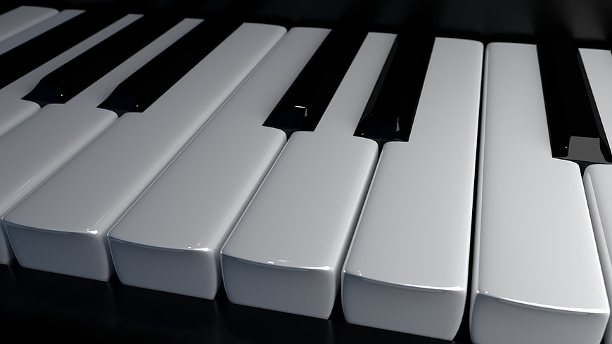 Close-up of glossy white and black piano keys on a dark background