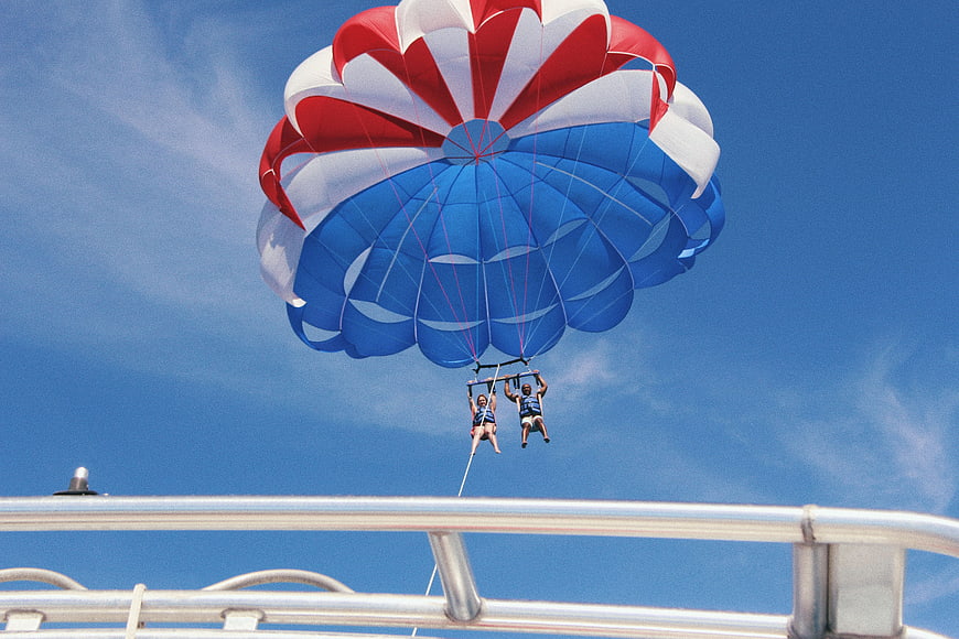 Parasailing Adventure with Red, White, and Blue Canopy