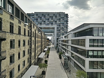 Modern Urban Alleyway Between Brick and Glass Buildings