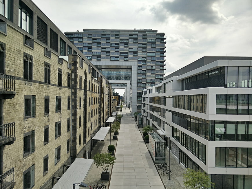 Modern Urban Alleyway Between Brick and Glass Buildings