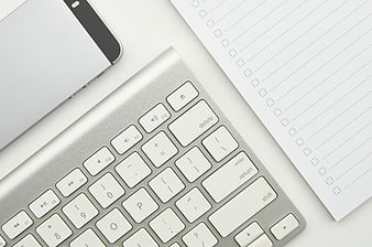 Minimalist Office Desk with Keyboard, Smartphone, and Checklist Notepad