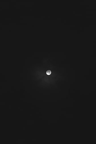Full moon in dark night sky with subtle clouds