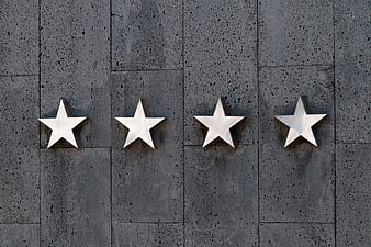 Four Silver Stars on Gray Stone Wall