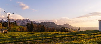 Wind Turbine in Alpine Meadow at Sunset