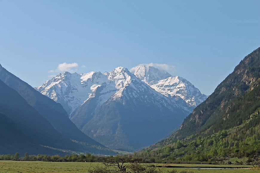 Snow-Capped Mountain Peaks in a Green Valley Landscape