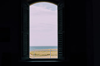 Open Window View of Ocean and White Fence