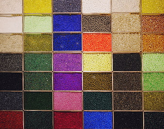 Colorful seed beads organized in grid compartments