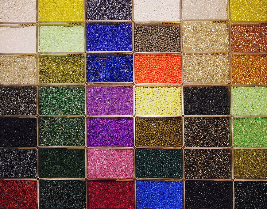 Colorful seed beads organized in grid compartments