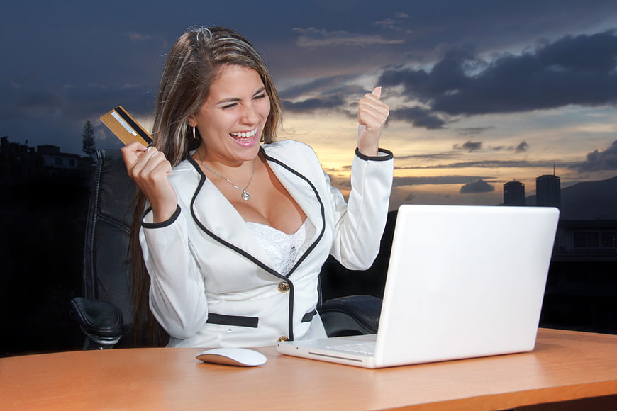Happy Business Woman Celebrating Online Purchase with Credit Card