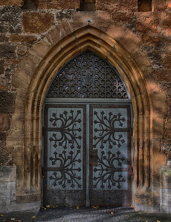 Historic Gothic Church Portal With Ornate Ironwork And Weathered Stone