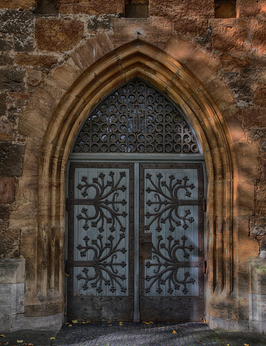 Historic Gothic Church Portal With Ornate Ironwork And Weathered Stone