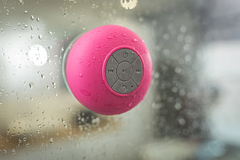 Pink Portable Bluetooth Speaker on Rainy Window