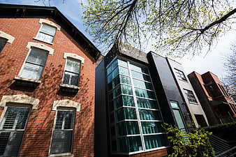 Modern Glass House Between Traditional Brick Row Houses