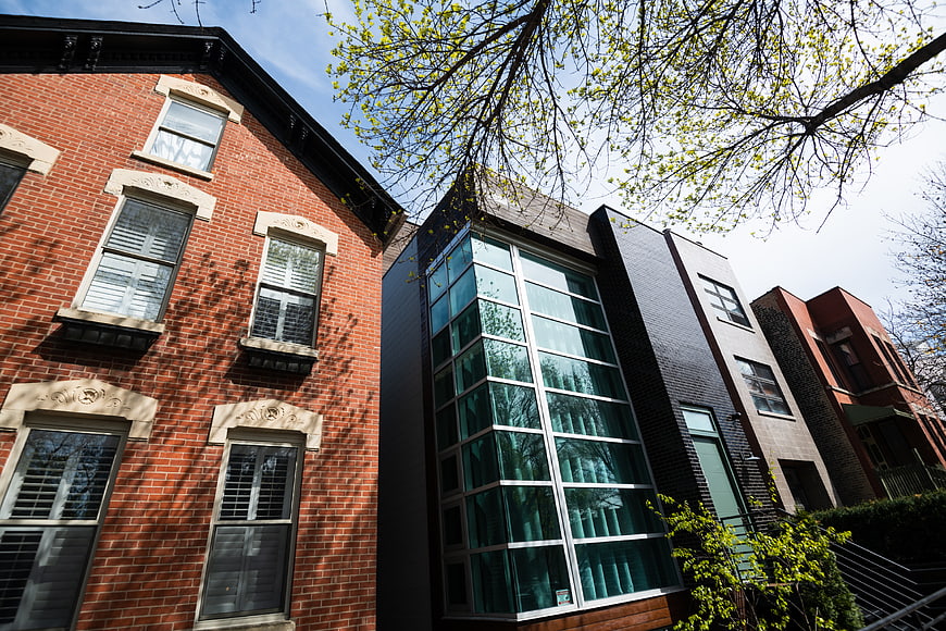 Modern Glass House Between Traditional Brick Row Houses