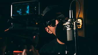 Musician recording in studio with camera filming