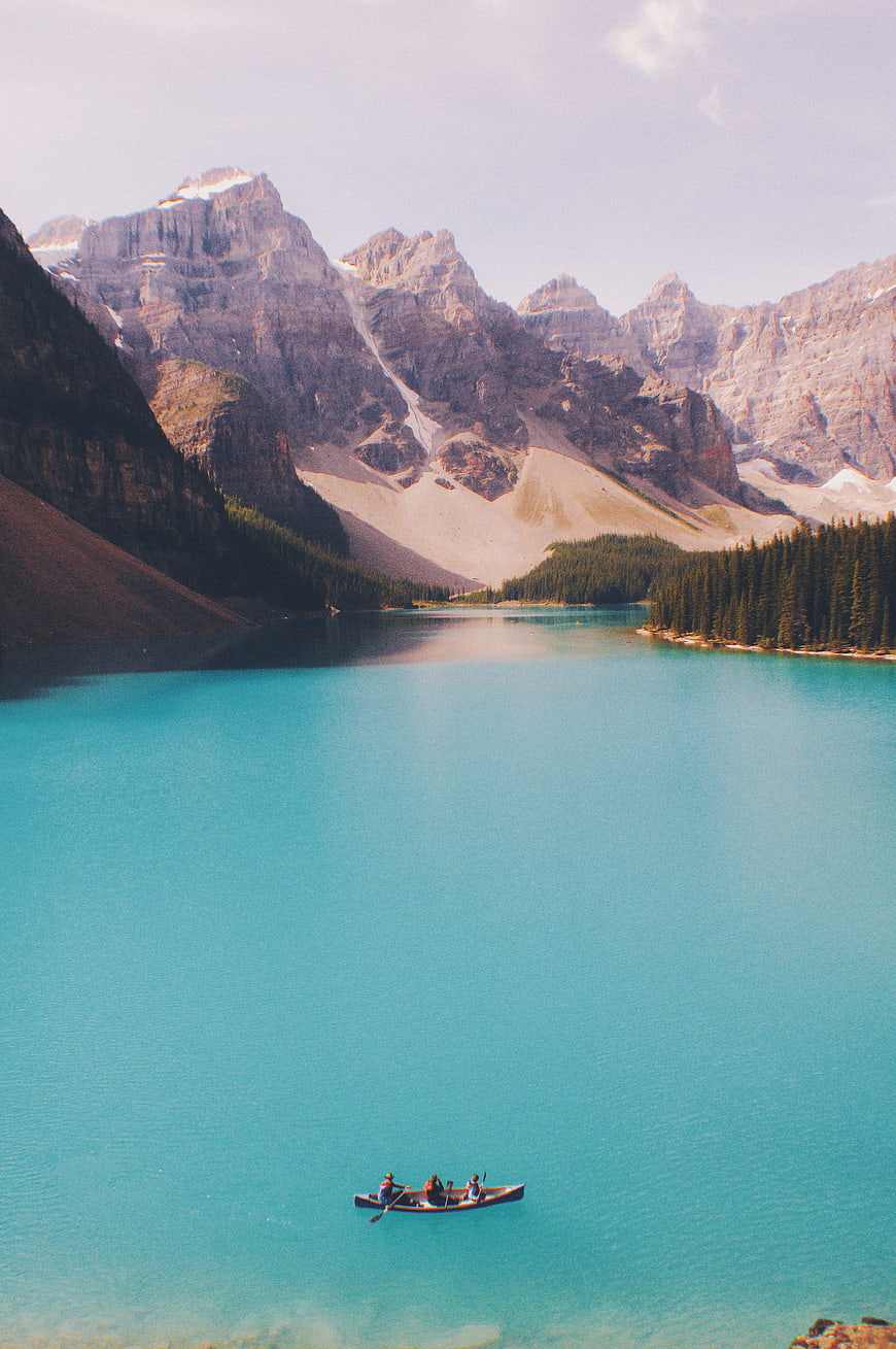 Canoeing on Turquoise Mountain Lake with Majestic Peaks