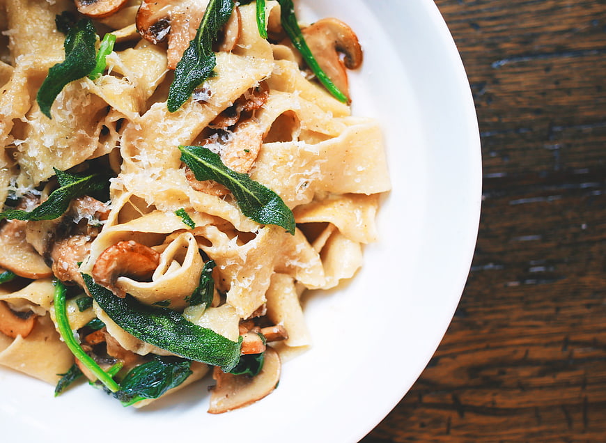 Overhead shot of pappardelle pasta with mushrooms and sage