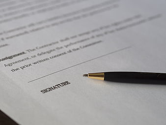 Pen on contract signature line ready for signing