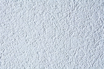 White textured plaster wall background close up