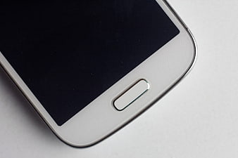 Close-up of white smartphone home button on white background