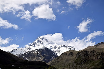 Majestic Snow-Capped Mountain Peak Under Blue Sky