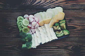 Top View of Healthy Cheese and Vegetable Platter on Wood