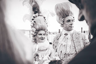 Senior couple in 18th-century rococo costumes and wigs