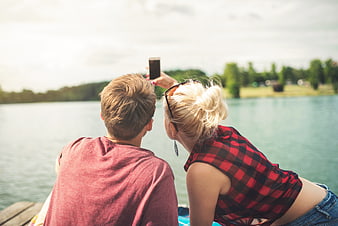 Couple Taking Selfie by Lake on Summer Day