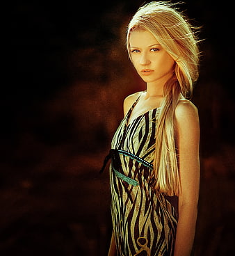 Portrait of blonde woman in zebra print dress with dramatic lighting