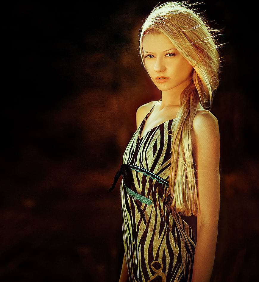 Portrait of blonde woman in zebra print dress with dramatic lighting