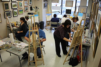 Adults Painting on Easels in a Community Art Studio