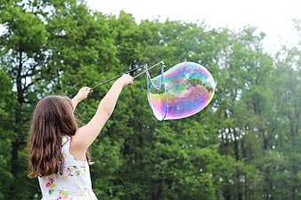 Girl Making Giant Soap Bubble in Green Park