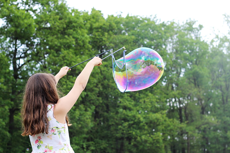 Girl Making Giant Soap Bubble in Green Park