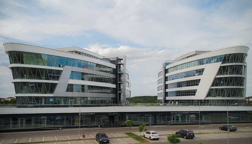 Modern glass office buildings with parking lot