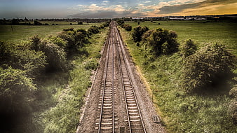 Aerial View of Railway Tracks Cutting Through Green Countryside