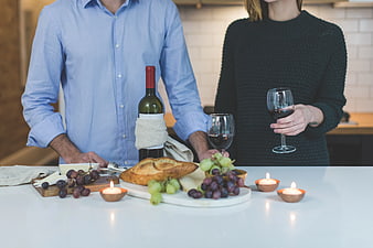 Couple Enjoying Wine and Cheese Platter in Kitchen