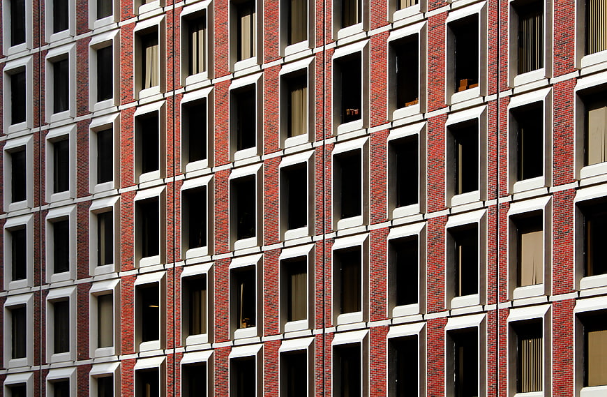 Red Brick Building Facade with Grid Window Pattern