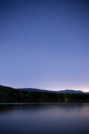Starry Night Sky Over Lake and Mountain Silhouette