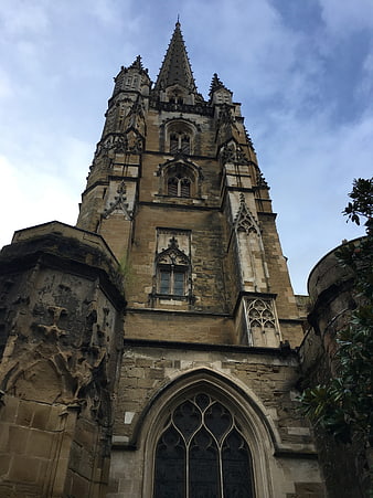 Low angle view of historic Gothic stone church tower