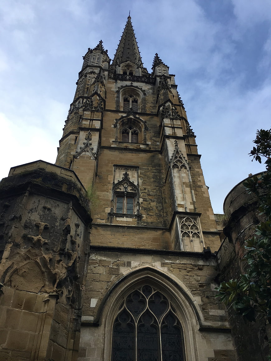 Low angle view of historic Gothic stone church tower