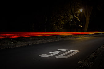 Long Exposure Red Car Light Trails on Night Road