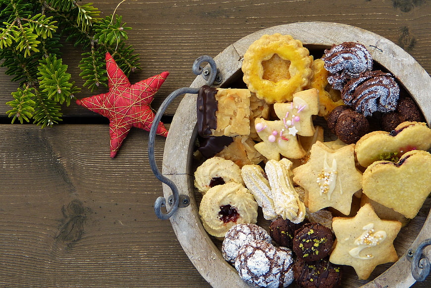 Top View of Christmas Cookies in Wooden Bowl with Pine Branches