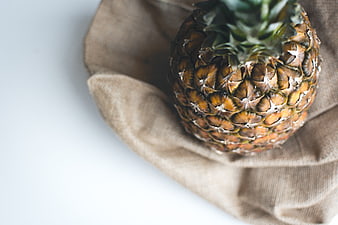 Fresh pineapple on linen cloth with copyspace