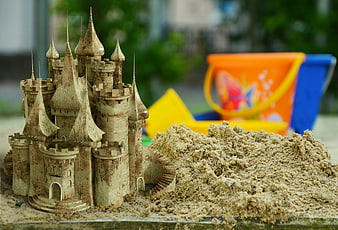 Detailed Sand Castle with Colorful Buckets in Sandbox