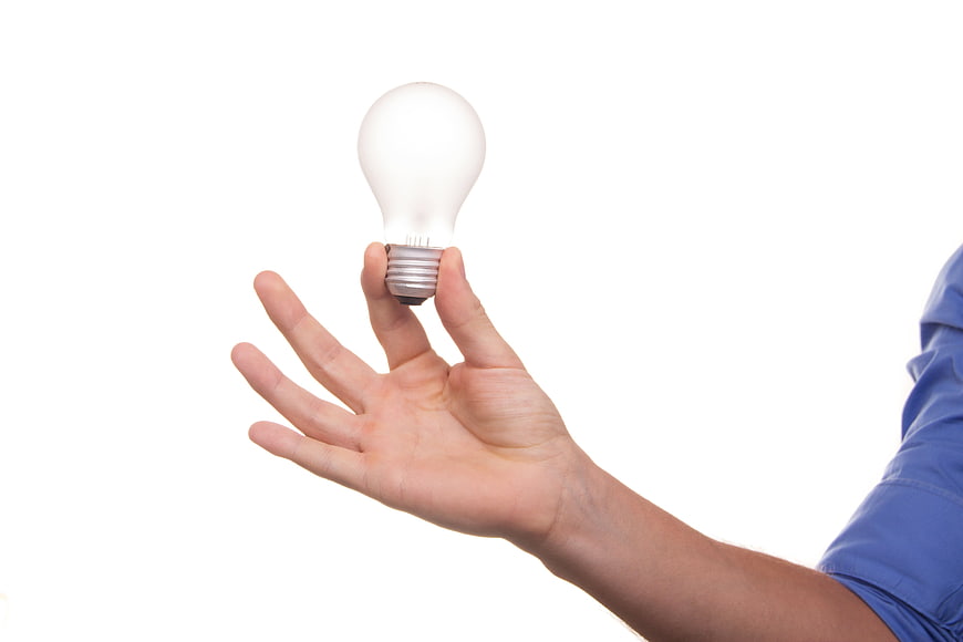 Hand holding light bulb concept on white background