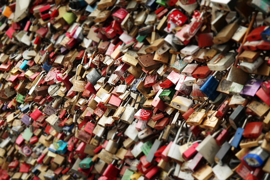 Colorful padlocks on a bridge railing symbolizing love