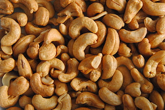 Close-up of roasted cashew nuts filling the frame