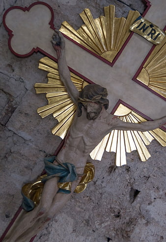 Statue of Jesus on Cross with Gold Rays